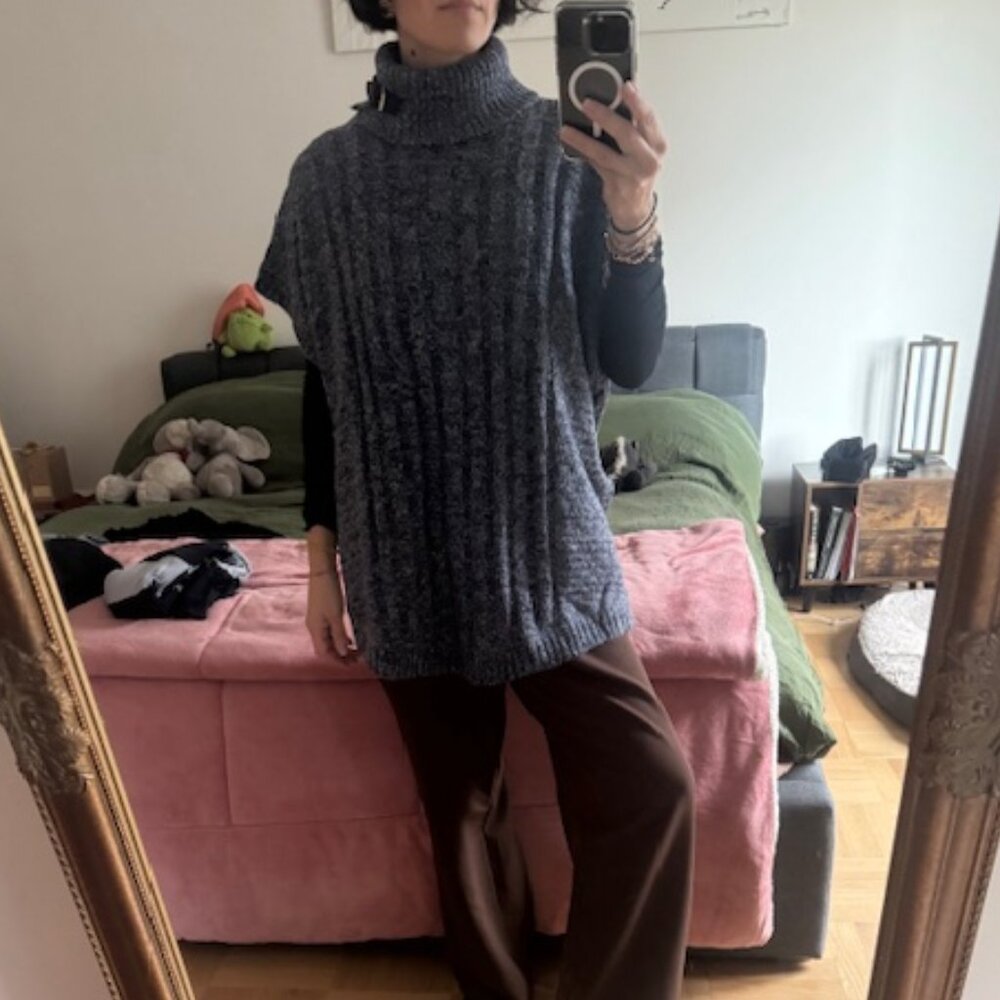 Cable-knit turtleneck cape with button detail on the side